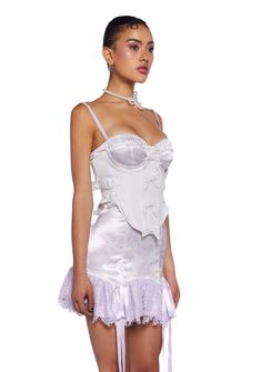 cuz make a statement on the dance floor. This underbust corset top has a linen construction with a satin lining, structured boning, an underwire bust, a satin ribbon lace-up design on the back, adjustable buckle closures on the sides, decorative bows on the front, a curved hem, and a side zipper closure. Underbust Corset Belt With Built-in Bra For Party, Feminine Underbust Corset With Built-in Bra, White Underbust Corset With Built-in Bra, Satin Corset Dress With Underwire, Fitted Lace Corset Dress In Coquette Style, Fitted Satin Corset Dress In Coquette Style, Fitted Lace Trim Corset For Parties, Elegant Underwire Corset With Lace Trim, Satin Corset With Built-in Bra And Underwire