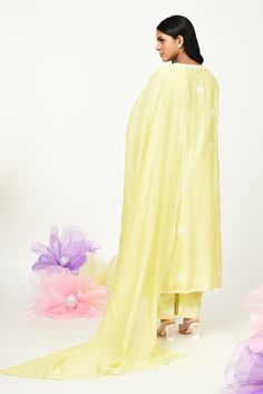 Yellow chanderi kurta with thread embroidery in floral placement pattern. Paired with cotton pant, inner and dupatta.
Components: 4
Pattern: Embroidery
Type Of Work: Thread, floral
Neckline: Round
Sleeve Type: Three quarter
Fabric: Chanderi
Color: Yellow
Other Details: 
Front button detailing
Lace embellished border
Embroidery on pant hem
Note: Potli shown in the image is not for sale
Occasion: Puja - Aza Fashions Placement Pattern, Kurta Set For Women, Types Of Work, Border Embroidery, Pattern Embroidery, Thread Embroidery, Fashion App, Kurta Set, Cotton Pants