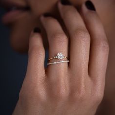 a woman's hand with a diamond ring on it