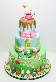 a three tiered cake decorated with animals and farm animals on it's sides