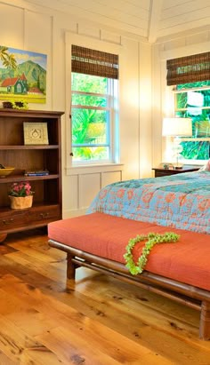 a bedroom with wood floors and white walls