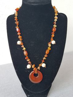 I only make one-offs!! Beautiful, handmade necklace with carnelian and cultured pearls, the highlight is the round carnelian pendant. Carnelian promotes courage, energy and a good mood. Physically, it should have a stimulating effect on the metabolism and circulation. Length: appr.  46 cm This article is finished and will be shipped within 1 working day. All items will be sent to you via a tracked or signed for delivery service. However, shipping times may vary as everything is shipped from Spai Handmade Red Agate Necklace, Handmade Orange Beaded Pendant Necklace, Handmade Brown Agate Crystal Necklace, Bohemian Carnelian Jewelry In Orange, Unique Handmade Amber Beaded Necklaces, Bohemian Orange Beaded Necklaces With Gemstones, Orange Gemstone Bohemian Beaded Necklace, Brown Carnelian Gemstone Necklaces, Unique Handmade Orange Necklaces