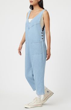 Rock a casual-cool vibe in this lightweight denim jumpsuit designed with front patch pockets and a cropped length. 23 1/2" inseam; 17 1/2" leg opening Side button closure Deep V-neck Sleeveless Front patch pockets 76% cotton, 24% rayon Machine wash, dry flat Made in Turkey Light Wash Overall Jumpsuit With Pockets, Light Wash Overall Jumpsuits And Rompers With Pockets, High Rise Denim Jumpsuit With Pockets In Utility Style, Casual Shortalls With Side Pockets, Medium Wash Relaxed Fit Bib Front Jeans, Medium Wash Relaxed Fit Denim Utility Jumpsuit, Casual Dark Wash Bib Front Overalls, High Rise Denim Blue Utility Jumpsuit, Utility Denim Blue Jumpsuit With Side Pockets