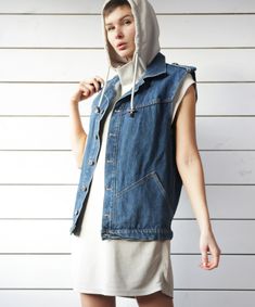 Unisex vintage blue denim sleeveless jacket casual biker style vest. Front button closure, two side pockets, shoulder tabs, no lining. Material is 100% cotton. Made in Britain. Size M on tag. Measured laying flat (please double for circumference): 25'' / 63.5 cm long 20.5'' / 52 cm armpit to armpit 19'' / 48 cm waist Great vintage condition. Cheap Denim Blue Workwear Vest, Streetwear Denim Vest With Pockets For Fall, Fall Streetwear Denim Vest With Pockets, Fall Denim Vest With Pockets For Streetwear, Dark Wash Cotton Vest, Washed Denim Blue Cotton Vest, Urban Denim Vest With Pockets For Winter, Urban Winter Denim Vest With Pockets, Retro Dark Wash Cotton Denim Vest