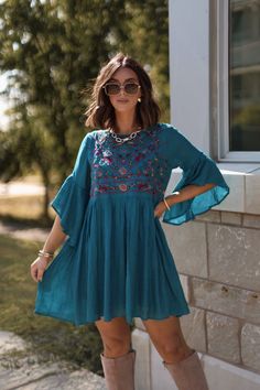 Bring a touch of playful elegance to your wardrobe with the Whimsical Teal Floral Embroidered Mini Dress! With its delicate details and flowy silhouette, this dress is perfect for any occasion that calls for a little fun and flirtation. Designed with airy bell sleeves, this dress offers a romantic and free-spirited feel. Featuring beautiful floral embroidery, this dress brings a whimsical, boho charm to your look. Pair it with your favorite boots for an effortlessly chic look that's ready for any adventure. Garden Party Midi Dress With Embroidered Hem, Flowy Floral Embroidered Dress, Bohemian Midi Dress With Floral Embroidery For Garden Party, Casual Flowy Floral Embroidered Dresses, Flowy Embroidered Dress With Floral Details, Summer Midi Dress With Embroidered Hem, Floral Embroidery Short Sleeve Sundress, Flowy Embroidered Beach Dresses, Flowy Embroidered Boho Dress For Vacation