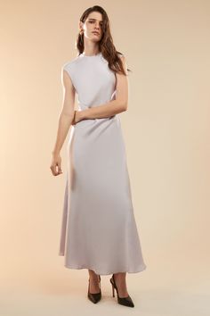 Sultry, elevated and entirely elegant, the Peggy A-line Slip Dress creates a fluid aesthetic that feels feminine and effortless. Made from a satin fabric, it features a high neckline, extended shoulders and an open back to draw the eye. SIZING: True to size. AU: Model wears a size 8 / US: Model wears a size 4.FABRICATION: Main: 100% polyester - A-line - High neckline - Open back Fluid Aesthetic, Corsets Fashion, Mum Jeans, Day To Night Dresses, White Cocktail Dress, Essential Dress, Bodysuit Fashion, Wide Jeans, High Neckline