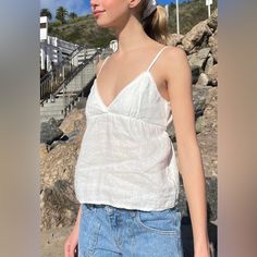 Flowy Tank Top With V-Neck, Scalloped Trim, Adjustable Straps, And Tie In The Back Fabrics: 100% Linen Measurements: Length: 16" (40cm) , Bust: 13" (33cm) Made In: China Summer Cotton V-neck Camisole, Trendy V-neck Camisole For Vacation, Fitted V-neck Tank Top For Daywear, Trendy V-neck Camisole For The Beach, Trendy V-neck Camisole For Day Out, Summer Cotton V-neck Top For Day Out, Chic Linen V-neck Top, Fitted V-neck Camisole For Vacation, Summer V-neck Tank Top For Daywear