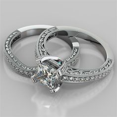 two white gold wedding rings with diamonds on the sides and an engagement ring in the middle