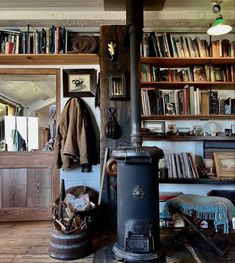 an old fashioned stove in a room with bookshelves