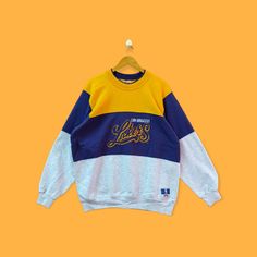 Vintage Los Angeles Lakers colourblock sweatshirt Los Angeles Lakers crewneck sweater pullover streetwear sports style yellow purple xlarge by YoungmodernCo on Etsy Yellow Sweatshirt For Sports In Fall, Yellow Crew Sweatshirt For Winter, Throwback Long Sleeve Sweatshirt For Streetwear, Yellow Crew Neck Sweatshirt For Winter, Sporty Patchwork Sweatshirt For College, Purple Crew Sweatshirt For Winter, Winter Color Block Tops For Streetwear, Purple Tops With Ribbed Cuffs For Streetwear, Sporty Crew Neck Sweater With Contrast Color