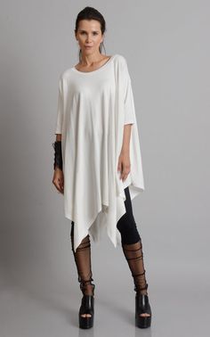 Oversize Long Tunic - METT0105 Be modern in white with this maxi tunic. Because of the loose fit, this top is super easy to wear and perfect for an every day use. It has beautiful asymmetric draping and can easily be paired with a lot of different pants and leggings. Put a pair of heels and a few accessories to make the outfit whole. This asymmetric tunic is made of 100% cotton. NOTE! The color is off white! WHEN YOU PLACE AN ORDER YOU MUST LEAVE A TELEPHONE NUMBER AND CORRECT COORDINATES! WE DO Oversized White Blouse For Layering, White Cotton Lagenlook Blouse, Oversized Spring Tunic Tops, White Stretch Blouse For Daywear, Oversized Tunic Tops For Spring, Oversized Tunic Tops For Day Out, Oversized White Half Sleeve Blouse, White Oversized Half Sleeve Blouse, White Oversized Half-sleeve Blouse