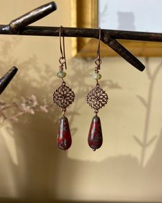 "Details & measurements: ~ Earthy deep red and swirling sea green Czech glass teardrop beads with Picasso finish (20 x 10mm) dangle from beautifully detailed, dainty antique copper filigree charms (13 x 17mm)  ~ Accented with Czech glass rondelle beads in light green w/ rustic Picasso finish (3 x 5mm) ~ They hang from antique copper ear wires ~ Earrings hang almost 2 3/4\" long ♡ Packaged safely & sustainably in a kraft box with cotton ribbon & dried organic florals. This makes for a beautiful gift, or something pretty for yourself! All packaging materials are zero waste and also reusable. ♡ As well, we always aim to ship with plastic-free packing materials. Sustainability is an integral part of our lives, and we bring that same dedication to our small business." Bohemian Brass Earrings In Rust Color, Adjustable Copper Teardrop Bohemian Earrings, Bohemian Rust Earrings With Ear Wire, Bohemian Rust Brass Earrings, Bohemian Hypoallergenic Bronze Earrings, Bohemian Bronze Hypoallergenic Earrings, Hypoallergenic Bohemian Bronze Earrings, Bohemian Nickel-free Rust Earrings, Bohemian Rust-colored Nickel-free Earrings