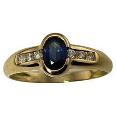 Vintage 18 Karat Yellow Gold Sapphire and Diamond Ring Size 8.5- This lovely ring features one oval sapphire (7 mm x 5 mm) and six round brilliant cut diamonds set in classic 18K yellow gold. Shank: 2 mm. Approximate total diamond weight: .12 ct. Diamond clarity: VS1 Diamond color: G Ring Size: 8.5 Weight: 1.9 dwt. / 3.1 gr. Tested 18K gold. Very good condition, professionally polished. Will come packaged in a gift box or pouch (when possible) and will be shipped U.S. Priority Mail Insured. DV10 G Ring, Vs1 Diamond, Sapphire And Diamond Ring, Sapphire Diamond Ring, Lovely Ring, Diamond Color, Natural Sapphire, Sapphire Diamond, Round Brilliant Cut Diamond