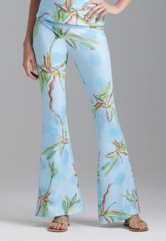 Woman wearing blue green bamboo printed stretch knit pants with matching printed tank top by Ala von Auerperg for resort 2024 Floral Print Beach Loungewear Bottoms, Tropical Blue Bottoms For Summer, Fitted Hawaiian Style Bottoms For Poolside, Floral Print Beachwear Pants For Spring, Spring Tropical Print Pants, Tropical Wide-leg Pants For Spring, Tropical Print Pants For Summer, Tropical Wide Leg Pants With Tropical Print, Summer Pants With Tropical Print For Spring