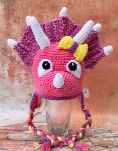 a crocheted pink and yellow hat with horns