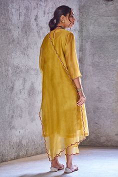 Mustard yellow kurta with mirror embroidered placement motif on yoke.
Component: 1
Embroidery
Neckine: Round
Sleeve Length: Three fourth
Fabric: Chanderi
Color: Yellow
Kutch hand embroidery
Scallop hem on sleeves
Note: Pant and dupatta worn by model are not for sale. - Aza Fashions Pleated Salwar, Scallop Dupatta, Kurta Pants, Easy Clothing, Blouse Yoke, Kurta For Women, Yellow Mustard, Kurta With Pants, Silk Organza