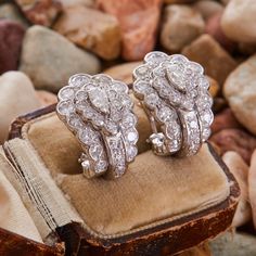 These captivating "J" style earrings are each centered with a pear brilliant cut diamond in a five-prong setting. The earrings are accented with fourteen (14) round single cut diamonds and thirteen (13) round brilliant cut diamonds in bead settings. The earrings measure 22.0mm long by 16.1mm wide and 19.3mm deep, finished with posts and omega backs. Luxury Pear-shaped Single Cut Diamond Earrings, Formal Pear-shaped Diamond Earrings With Single Cut Diamonds, Platinum Pear-shaped Diamond Earrings For Formal Occasions, Formal Teardrop Single Cut Diamond Earrings, Luxury Pear-shaped Brilliant Cut Diamond Earrings, Classic Marquise Cluster Diamond Earrings, Classic Marquise Diamond Cluster Earrings, Luxury Earrings With Single Cut Diamonds, Luxury Marquise Brilliant Cut Diamond Earrings