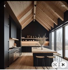 a kitchen with wooden ceilings and black cabinets