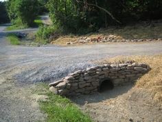 a stone tunnel built into the side of a road