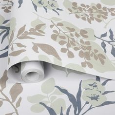 a wallpaper with flowers and leaves on it, as well as a roll of tape