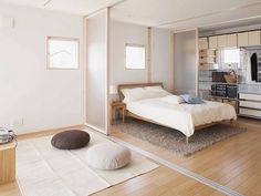 a bedroom with white walls and wood floors