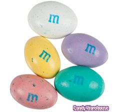 four eggs with the letter m on them are shown in different colors and font options