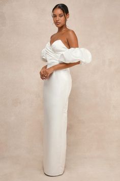 Ensure that your big day is truly unforgettable with a pristine look like the Lulus Profound Love White Satin Pleated Puff Sleeve Maxi Dress! Sleek woven satin lends a luxe essence to this gown that features a sweetheart-style neckline (with hidden no-slip strips) and a chic, pleated bodice with a surplice-inspired design, supportive padding, low-cut back, and side boning. The high, fitted waist tops a column skirt that falls to an elegant maxi hem with a flirty kick pleat at the back. If you're Taffeta Wedding Dress With Sweetheart Neckline, Wedding Taffeta Dress With Sweetheart Neckline, Wedding Dress With Sweetheart Neckline In Taffeta, Elegant Taffeta Gown With Sweetheart Neckline, Elegant Taffeta Evening Dress For Wedding, Elegant Voluminous Satin Dress, Elegant Voluminous Party Gown, Formal Gown With Fitted Bodice And Puff Sleeves, Elegant Satin Bridesmaid Dress With Sweetheart Neckline