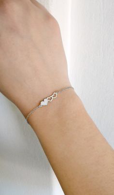 "14K Gold Triple Heart Bracelet, 9K Solid gold bracelet, Dainty gold bracelet, Love bracelet, Gift for her, Hearts bracelet, Rose Gold bracelet, 9K Gold bracelet, Delicate gold bracelet, FREE EXPRESS SHIPPING Beautiful and delicate bracelet with a triple heart charm made in 14K or 9K solid gold. \"One is loved because one is loved. No reason is needed for loving.\" -- Paulo Coelho Whisper...Love is in the air! -------------------------------------------------- D E T A I L S 14K Solid Gold or 9K White Gold Heart Charm Bracelet For Anniversary, White Gold Heart Bracelet With Charm For Anniversary, White Gold Double Heart Bracelet For Valentine's Day, White Gold Heart Bracelet For Anniversary And Mother's Day, Delicate Adjustable Heart Bracelet For Anniversary, Dainty Jubilee Charm Bracelet For Anniversary, Silver Heart Bracelet For Anniversary Gift, Silver Heart Bracelets For Anniversary, Silver Heart Bracelets For Anniversary Gift