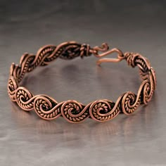 The bracelet is made of pure copper wire. The copper is artificially aged with patination, which gives an antique look and makes the details of the bracelet more expressive. After patination, the bracelet was polished to a shine, which gives a beautiful aesthetic appearance to the bracelet. The bracelet is covered with a protective varnish to prevent darkening.You will receive the exact bracelet you see in the photos.The bracelet can be combined with any wardrobe and emphasize your uniqueness and style. Bracelet Width: 0.4" (1 cm)  PLEASE NOTEChoose the desired length of the bracelet from the suggested options. To correctly choose the size of the bracelet, you need to add 0.6" (1.5 cm) to the size of your wrist girth. You will get the length of the bracelet that suits you.For example. If y Wire Wrap Bangle, Celtic Wire Jewelry, Copper Jewelry Diy, Wire Weaving Techniques, Metal Art Jewelry, Wire Jewelry Patterns, Wire Crochet Jewelry, Wire Wrap Jewelry Designs, Wire Jewelry Making