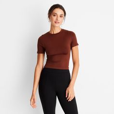 This Seamless Jersey Crop Top from A New Day™ in a solid colors offers easy pairing with a range of looks. Fashioned in a cropped length, it features a classic crewneck and a slim silhouette to give you a fitted look. The lightweight fabric with added stretch and a seamless design offers a more comfortable fit, and you can wear it with your choice of bottoms to create a range of versatile styles. . A New Day™: Style that goes wherever you do. High Stretch Ribbed Basic Tops, Basic Solid Cropped T-shirt With Ribbed Detail, Versatile Seamless Fitted Top, Stretch Crop Top T-shirt In Solid Color, Fitted Solid Top For Loungewear, Everyday Solid Stretch Crop Top, Solid Stretch Crop Top For Everyday, Basic Cropped T-shirt For Loungewear, Versatile Cropped Seamless Tops