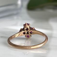 Details: Super sweet Victorian ring with diamond and pink/red rubies. The setting reminds me of flower. The ring is 14K rose gold, and has been tested. There are no markings on the interior of the band. There are four 3.25mm rubies and one 2mm diamond. Please ask all necessary questions prior to placing an order. Measurements: The size is 7 1/4 US and can be sized for a fee. Condition: The overall all condition of this ring is very good. Dainty Oval Ruby Ring In Rose Gold, Dainty Rose Gold Oval Ruby Ring, Hallmarked Rose Gold Ruby Ring, Oval Rose Gold Hallmarked Ruby Ring, Heirloom Ruby Ring In Rose Gold For Anniversary, Ruby Rings In Pink Gold For Wedding, Rose Gold Ruby Cluster Ring With Gemstones, Pink Ruby Ring With Rose Cut Diamonds, Oval Pink Gold Ruby Ring For Wedding