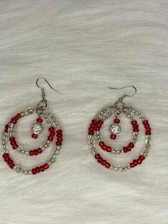 Hi Everyone,  Check out these pretty earrings out, Handmade Earrings, Red, Clear Beads, Silver Double Hoop Dangle Earrings. Handmade fashion jewelry accessories perfect simple gifts for her and for for everyone that loves earrings. These red and silver beaded hoop earrings can go everyday look for women and her fashion accessory. The length is about 3 inches from top to bottom. About 1.5 inches wide. Thank you for looking at my jewelry shop. Small Gold Chain, Christmas Party Crafts, Wire Earrings Handmade, Silver Wire Earrings, Henderson Nevada, Hoop Dangle Earrings, Red And Silver, Swarovski Beads, Small Beads