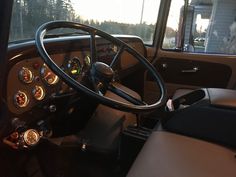 the steering wheel and dashboard of an old truck