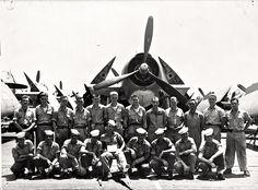 a group of men standing next to each other in front of an airplane