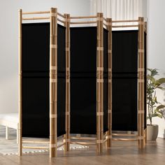 three black privacy screens in a living room