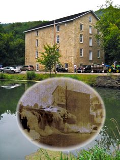 an old photo of a building next to a body of water