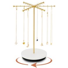 a jewelry stand with several necklaces hanging from it's sides and an arrow pointing to the top