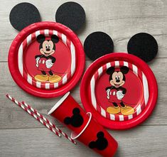 mickey mouse plates and cups with candy canes on the table next to each other