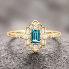 Step into the elegance of a bygone era with our Natural London Blue Topaz Ring, beautifully set in 14K yellow gold vermeil. This exquisite engagement ring draws inspiration from the opulent Art Deco period, blending vintage charm with timeless sophistication.►The centerpiece is a stunning London blue topaz, renowned for its deep, captivating hue that evokes the mysterious beauty of twilight skies. The intricate detailing of the band, adorned with delicate filigree patterns and sparkling accents, Luxury Classic Topaz Ring With Intricate Design, Luxury Art Deco Topaz Ring With Diamond, Luxury Topaz Ring With Intricate Design For Formal Events, Mysterious Beauty, London Blue Topaz Ring, Bygone Era, Art Deco Period, Art Deco Engagement Ring, Blue Topaz Ring