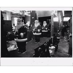 an old black and white photo of santas in the barbershop with their hair dryers