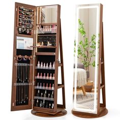 an open wooden jewelry cabinet next to a mirror