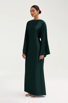 The Batool Dress is meant to have an oversized body design, complimented by an adjustable tie wrap. Size down if in between sizes. Indulge in luxury with the Batool Satin Maxi Dress. Its loose wide sleeves and lustrous satin fabric exude elegance, while the adjustable tie waist flatters your figure. Versatile design makes it perfect for Eid and beyond. Elevate your style with this exclusive piece. Model is 5'7 wearing size XS/58" Flowy Dress Hijab, Long Sleeve Maxi Satin Dress, Long Sleeves Formal Dress, Long Dresses Formal With Sleeves, Long Dresses With Long Sleeves, Black Dress Classy Plus Size, Modest Dress Wedding Guest, Graduation Dress Maxi, Satin Maxi Dresses