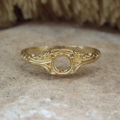 a gold ring sitting on top of a stone