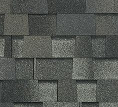 a close up view of a roof with gray shingles