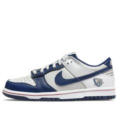 Nike's Dunk Low GS is a must-have sneaker for any big kid. This shoe celebrates the NBA's 75th anniversary with a Nets-inspired color scheme, complete with tumbled leather overlays in white and Blue Void. The lateral heel graphic nods to the franchise's current home in Brooklyn, while unique branding elements include a tongue tag with the 75th anniversary logo and a diamond-etched lace dubrae. The red stitching on the white midsole adds a pop of contrast, while the navy rubber outsole provides support and durability. (SNKR/Retro/Skate/Casual/Low Top/Brooklyn Nets) 75th Anniversary Logo, Branding Elements, Nike Nba, Anniversary Logo, Unique Branding, 75th Anniversary, Brooklyn Nets, Diamond Anniversary, Nike Dunk Low