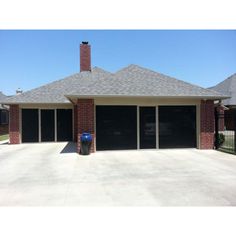 a garage with two cars parked in front of it