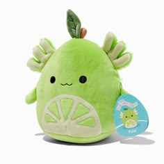 a green stuffed animal with leaves on it's head