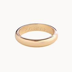 a gold ring with the word love engraved on it