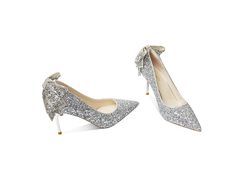 These silver heels are perfect for a night out or a special occasion. The bow brooch adds a touch of glamour and femininity to the overall look. The silver hue is timeless and easy to pair with any outfit. Whether you're looking for a dressy option for a special event or an everyday staple, these silver heels are sure to make a statement. Elegant Evening Heels With Satin Bow, Chic Evening Wedding Shoes With Bow, Glamorous Heels With Satin Bow For Events, Glamorous Silver Heels With Bow, Chic Wedding Shoes With Satin Bow For Party, Elegant Cocktail Heels With Satin Bow, Chic Wedding Shoes With Bow For Parties, Elegant Evening Wedding Shoes With Bow, Elegant Party Heels With Satin Bow