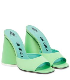 a pair of mint green high heels with an open toe